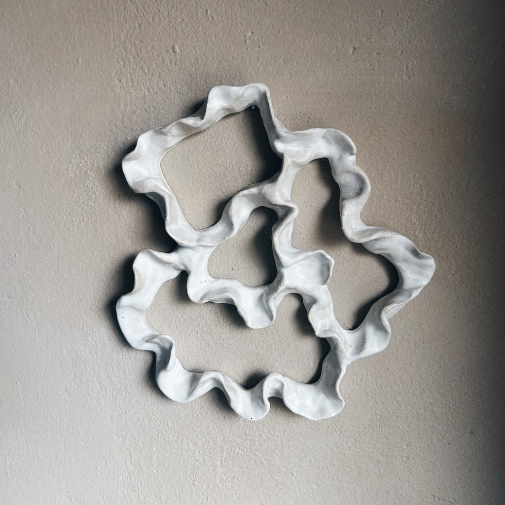 Decorative ceramic wall art with wavy edges close up