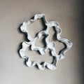 Decorative ceramic wall art with wavy edges close up