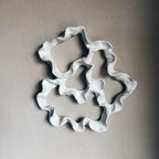 Decorative ceramic wall art with wavy edges close up