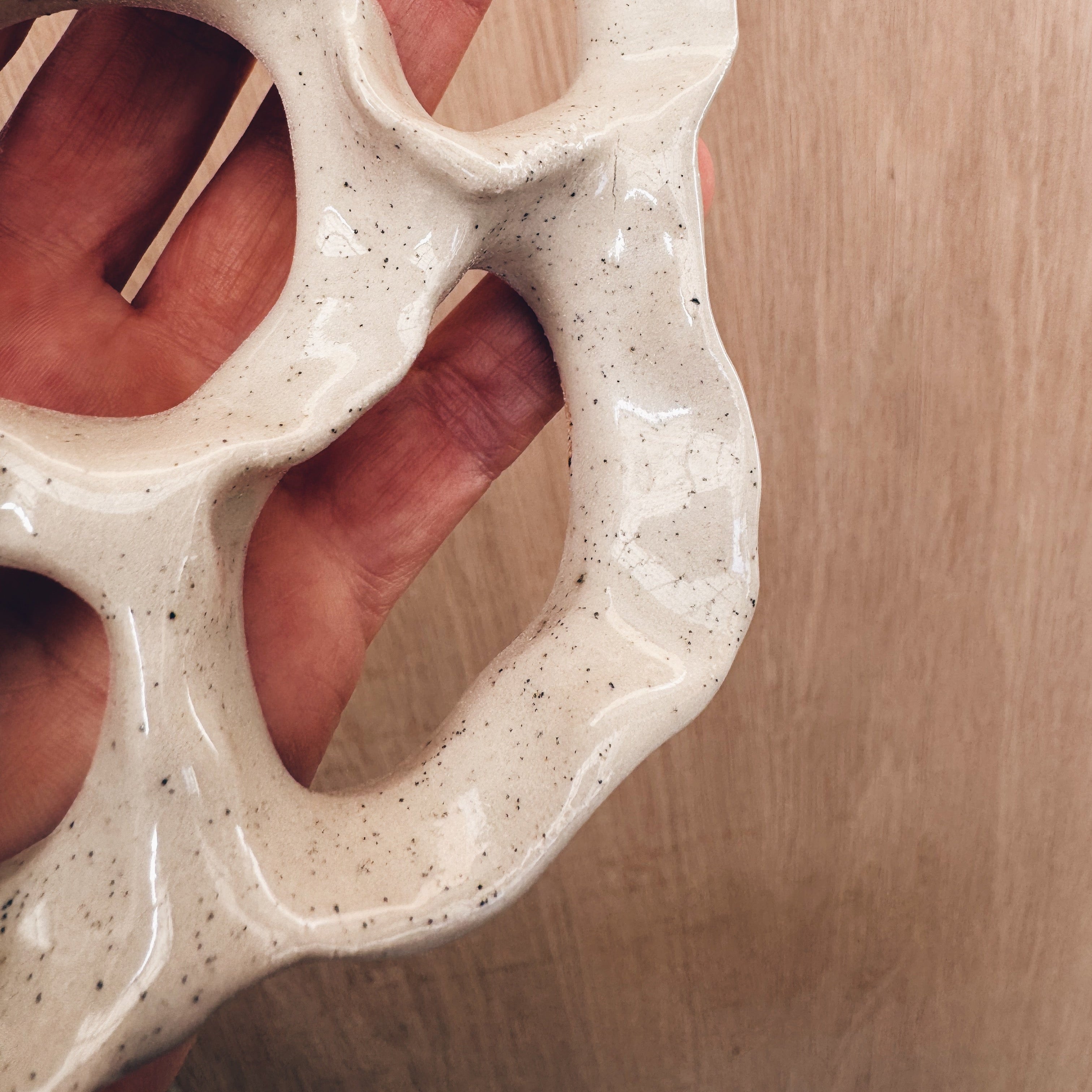 Close up of speckled glaze on ceramic wall art