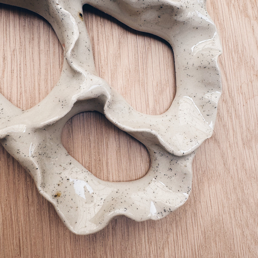 White ceramic coral wall art with fine texture details close up