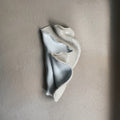 Handmade ceramic seashell wall piece with soft seafoam glaze and organic curved form